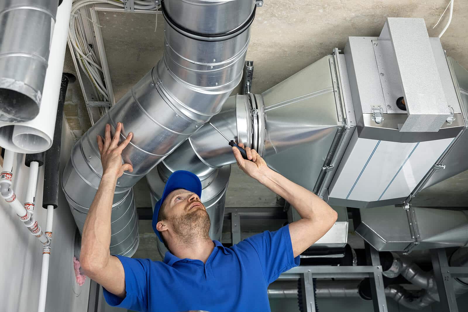 HVAC technician inspecting and repairing air ducts in Galt