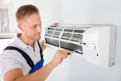 HVAC technician maintaining a ductless air conditioner in Galt